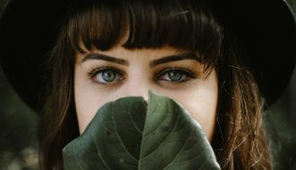 women beside green leaf