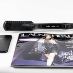 black corded hair flat iron beside magazine
