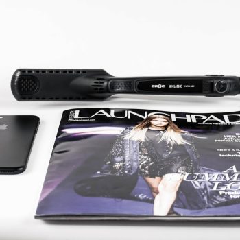 black corded hair flat iron beside magazine