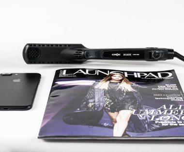 black corded hair flat iron beside magazine