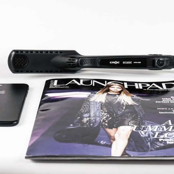 black corded hair flat iron beside magazine