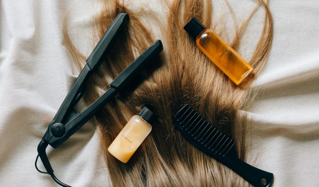Aesthetic flat lay of hair products and tools for styling and grooming.