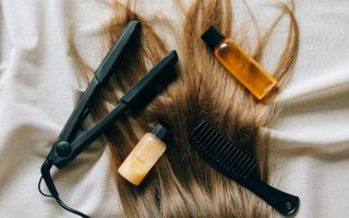 Aesthetic flat lay of hair products and tools for styling and grooming.