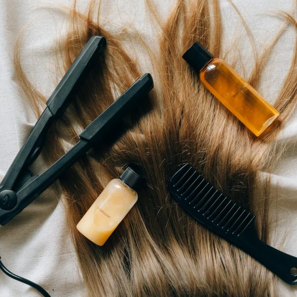 Aesthetic flat lay of hair products and tools for styling and grooming.